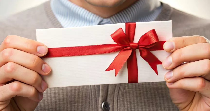 Employee holding their gift from work