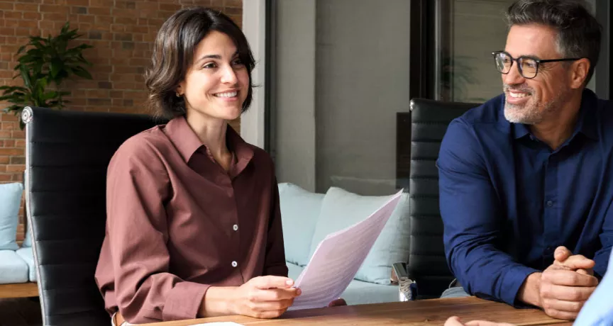 A new employee getting set up with paperwork during onboarding