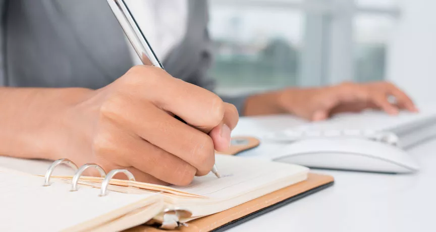 An administrator writing down a task