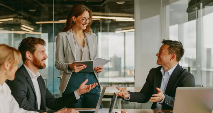 A high performing team at work collaborating and brainstorming around a table.