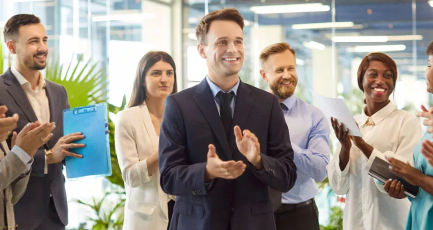 A group of employees celebrating with one another in the office