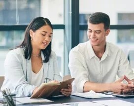 Four employee sitting around a table discussing a project