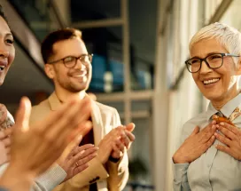 A team clapping for their colleague