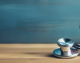 Image shows a toy heart and stethoscope sitting on a table