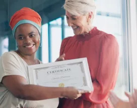 Shows a leader presenting an award to an employee