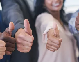 Shows six people giving a thumbs up