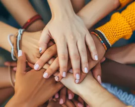 Shows a bunch of hands stacked together