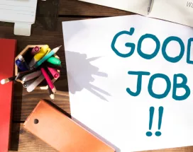 Shows a note that says "Good Job!" on a desk