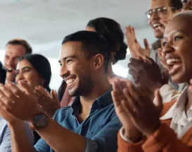 Shows several people clapping the same direction