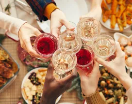 Employees celebrating at their office holiday party with drinks and food