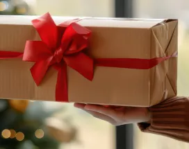 An employer gifting their employee a holiday gift