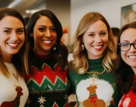 Employees smiling during a holiday team building activity