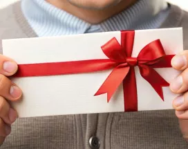 Employee holding their gift from work