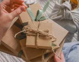A HR professional manually wrapping a reward for their employee recognition program.