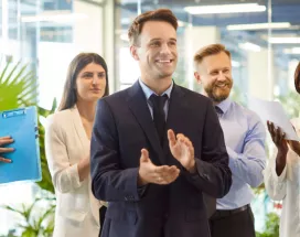 A group of employees celebrating with one another in the office