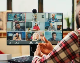 A remote new hire on their computer talking to their team virtually during onboarding