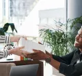 An employee giving their co-worker a holiday gift for appreciation