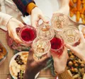 Employees celebrating at their office holiday party with drinks and food