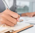 An administrator writing down a task