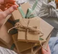 A HR professional manually wrapping a reward for their employee recognition program.
