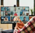 A remote new hire on their computer talking to their team virtually during onboarding