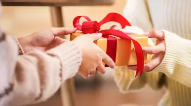 People giving each other a holiday gift