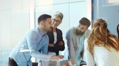An image showing a team of six people gathered around a table