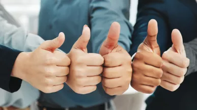 Five people giving a thumbs up