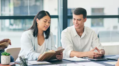 Four employee sitting around a table discussing a project