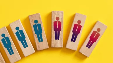 Shows wood blocks with peoples figures on them. The blocks are in a line, inclining. The last three are red and down turned.