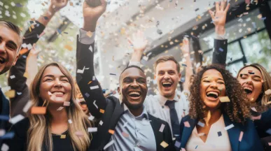 Image shows how a group of employees celebrating with confetti falling around them.