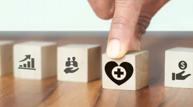 Image shows a hand grabbing a block with a heart on it.