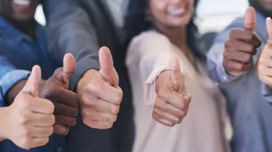 Shows six people giving a thumbs up