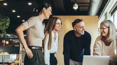 Engaged team working together over a laptop
