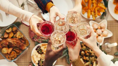 Employees celebrating at their office holiday party with drinks and food