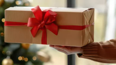 An employer gifting their employee a holiday gift