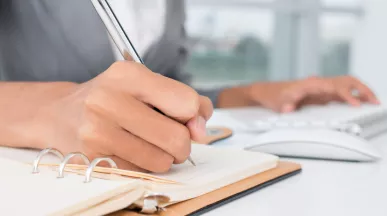 An administrator writing down a task