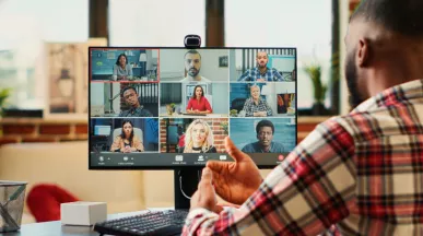 A remote new hire on their computer talking to their team virtually during onboarding
