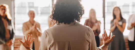 An employee giving a speech in front of their colleagues