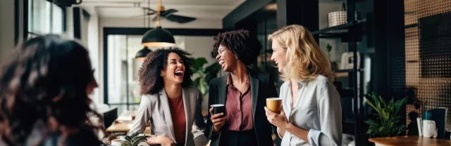 Three employees laughing together
