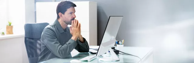 An upset employee sitting at their desk