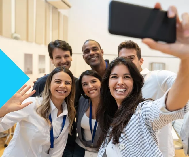 group taking selfie at work