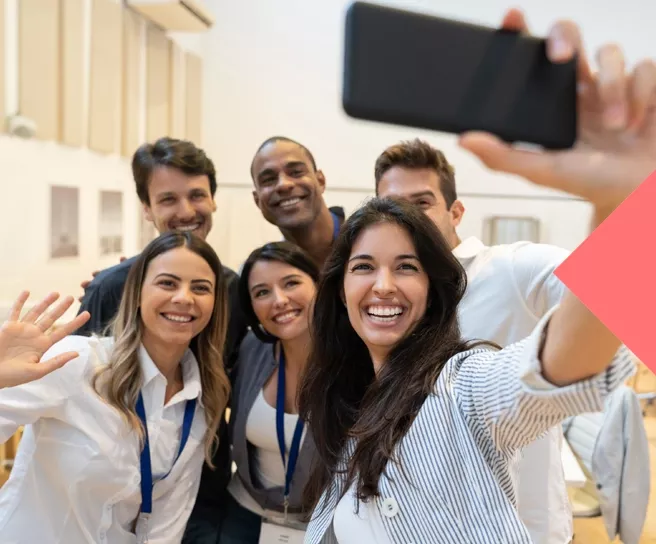 group taking selfie at work