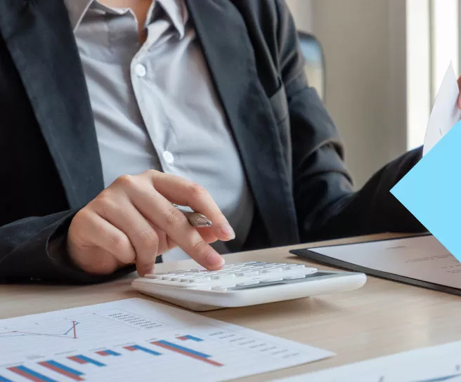 Employee reviewing employee recognition and rewards budget with a sheet and calculator