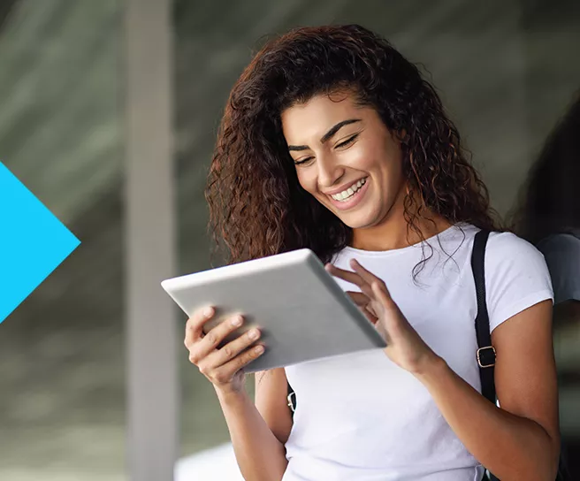 woman smiling at tablet